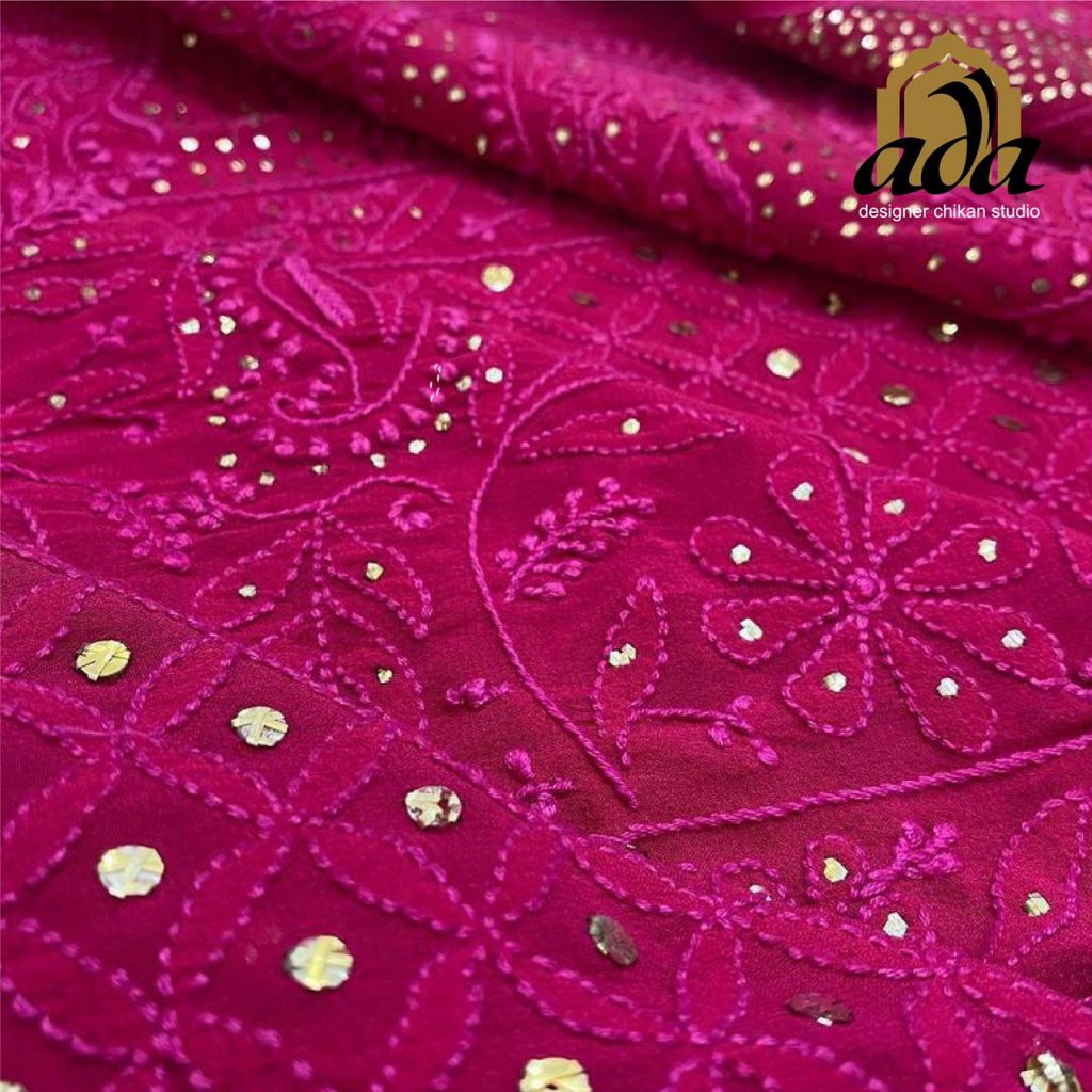 This image showcases fine hand work in a bright pink with metallic gold mukaish work 